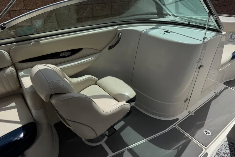 Slide: The Image of Interior of a 2002 Monterey 248LS Montura Bowrider, featuring beige seating and sleek design. - 23