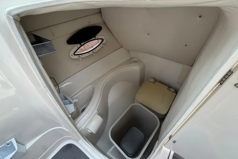 Slide: The Image of 2002 Monterey 248LS Montura Bowrider boat interior with compact restroom facilities. - 25