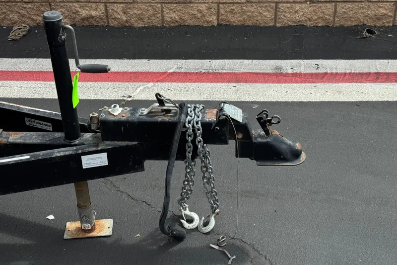 Slide: The Image of Trailer hitch of a 2002 Monterey 248LS Montura Bowrider on asphalt pavement. - 31