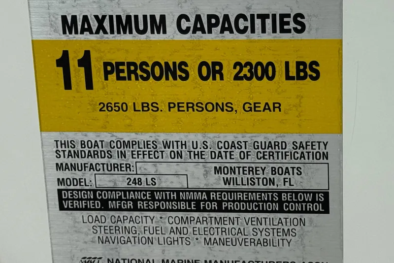 Slide: The Image of 2002 Monterey 248LS Montura Bowrider capacity label, 11 persons or 2300 lbs, safety compliance. - 33