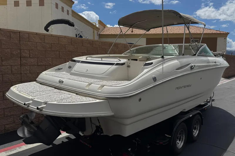Slide: The Image of 2002 Monterey 248LS Montura Bowrider boat on trailer, parked outdoors. - 5