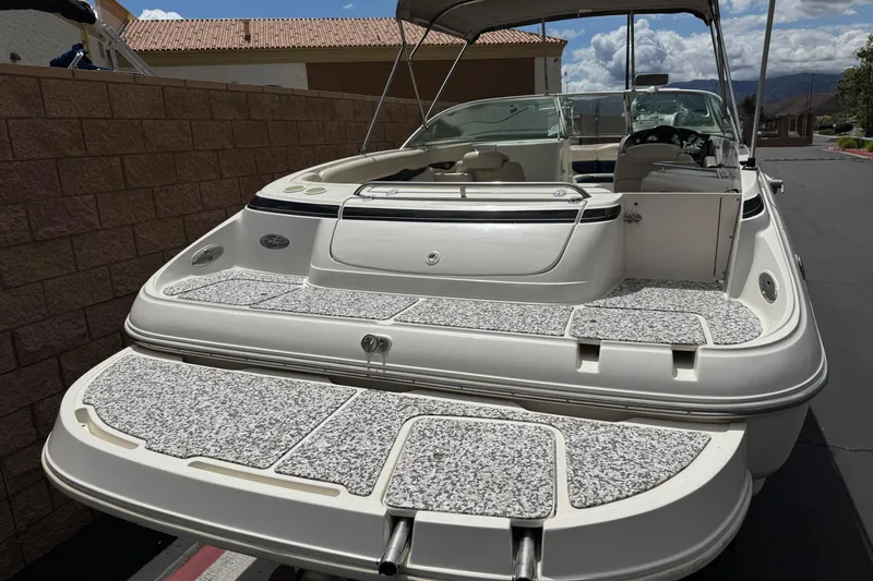 Slide: The Image of 2002 Monterey 248LS Montura Bowrider boat with spacious deck and seating area. - 6