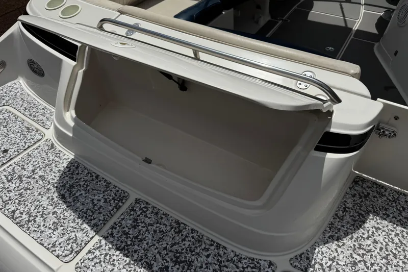 Slide: The Image of Open storage compartment on a 2002 Monterey 248LS Montura Bowrider boat. - 7