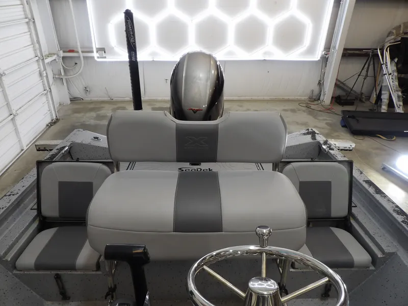 Slide: The Image of Interior of a 2019 Xpress H20B Bay boat with gray seating. - 16
