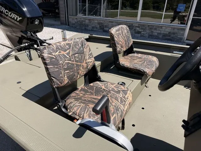 Slide: The Image of 2018 Tracker Grizzly 1754 SC with camouflage seats outdoors. - 5
