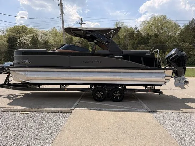 Slide: The Image of 2026 Avalon Catalina Quad Lounger boat on trailer, side view. - 16