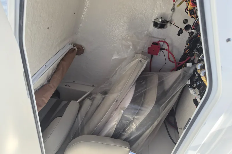 Slide: The Image of Interior view of a 2026 Key West 239 FS boat, showing wiring and storage area. - 17
