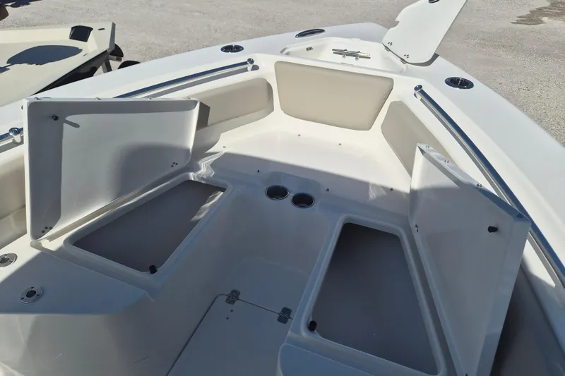 Slide: The Image of 2026 Key West 239 FS boat interior with open storage compartments and cup holders. - 19