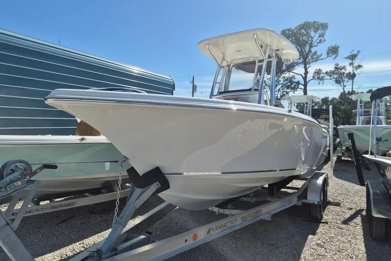 Slide: The Image of 2026 Key West 239 FS boat on trailer under clear blue sky. - 3