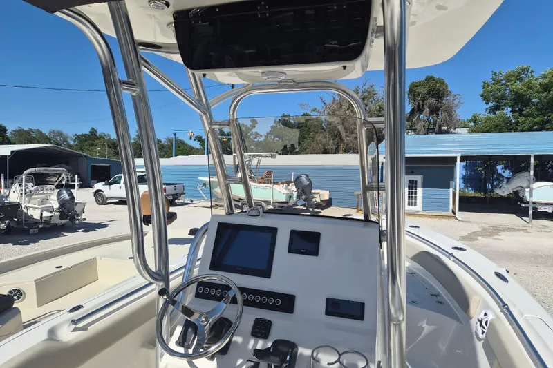 Slide: The Image of 2026 Key West 239 FS boat interior with modern dashboard and steering wheel. - 9