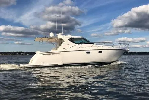 The Image of 2008 Tiara Yachts 4300 Sovran cruising on open water under a partly cloudy sky. - 0