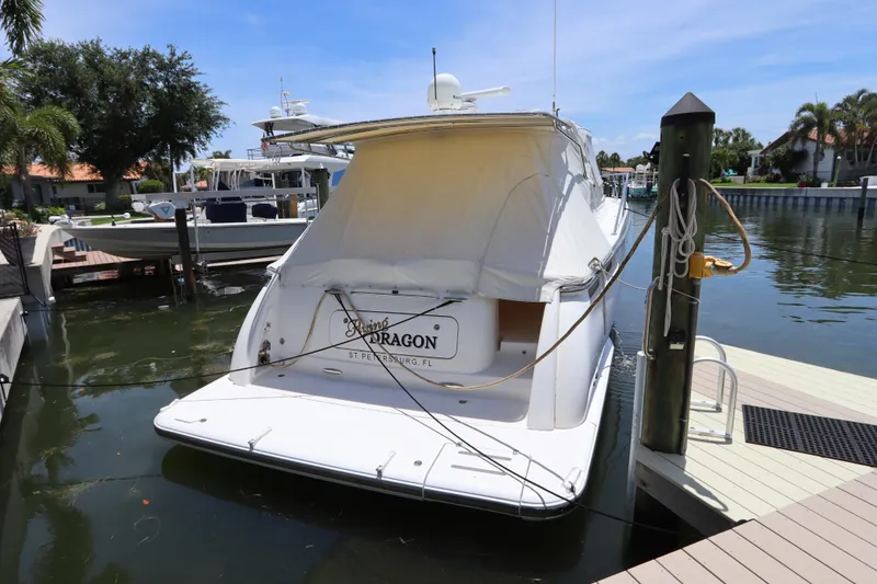Slide: The Image of 2008 Tiara Yachts 4300 Sovran docked at marina, rear view with cover. - 10