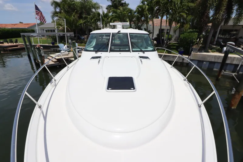 Slide: The Image of 2008 Tiara Yachts 4300 Sovran docked, showcasing sleek design and spacious deck. - 13