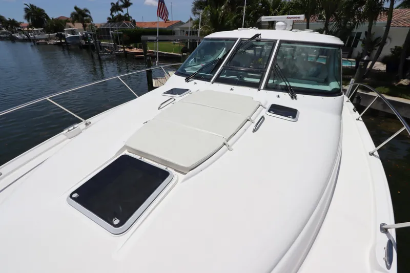 Slide: The Image of 2008 Tiara Yachts 4300 Sovran docked, showcasing sleek design and spacious deck. - 14