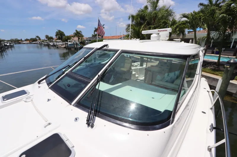 Slide: The Image of 2008 Tiara Yachts 4300 Sovran docked, showcasing sleek design and spacious cockpit. - 15