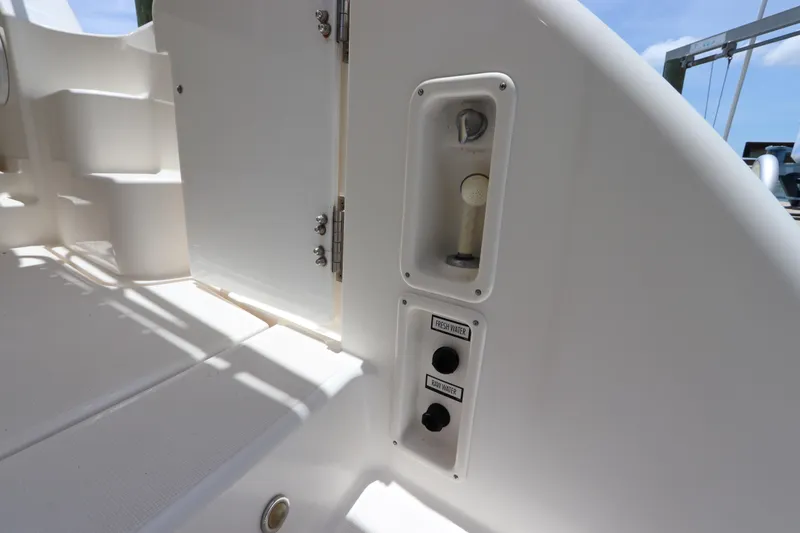 Slide: The Image of 2008 Tiara Yachts 4300 Sovran deck with water controls and storage compartment. - 19
