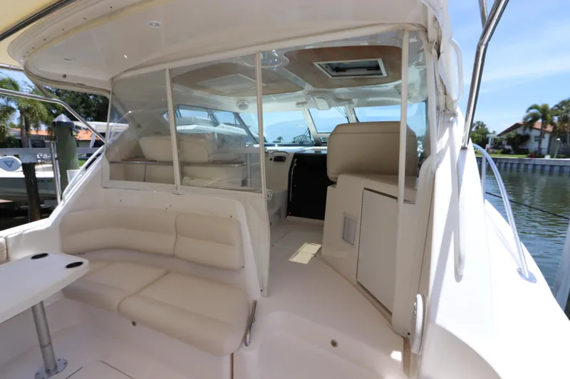 Slide: The Image of 2008 Tiara Yachts 4300 Sovran interior with beige seating and clear windows. - 22