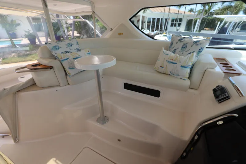 Slide: The Image of 2008 Tiara Yachts 4300 Sovran interior with cushioned seating and decorative pillows. - 28
