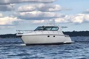 Slide: The Image of 2008 Tiara Yachts 4300 Sovran cruising on open water under a cloudy sky. - 3