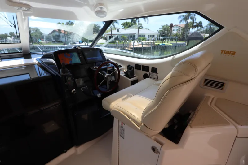 Slide: The Image of Helm of 2008 Tiara Yachts 4300 Sovran with leather seat and navigation controls. - 30