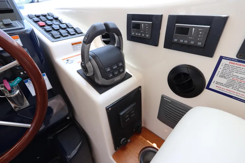 Slide: The Image of 2008 Tiara Yachts 4300 Sovran helm controls with joystick and digital displays. - 36