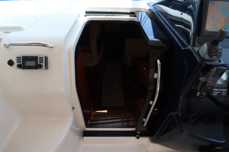 Slide: The Image of 2008 Tiara Yachts 4300 Sovran cabin entrance with control panel and navigation equipment. - 38