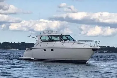 Slide: The Image of 2008 Tiara Yachts 4300 Sovran cruising on a calm lake under a partly cloudy sky. - 4