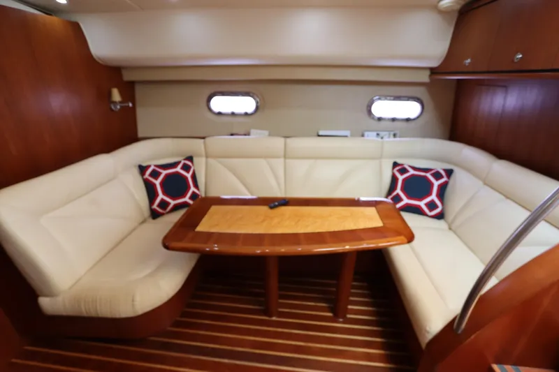 Slide: The Image of 2008 Tiara Yachts 4300 Sovran interior with cream leather seating and wooden table. - 41