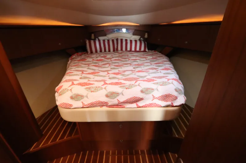 Slide: The Image of 2008 Tiara Yachts 4300 Sovran cabin with cozy bed and nautical-themed bedding. - 44