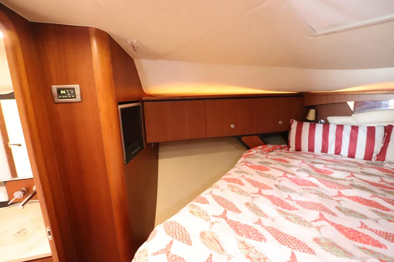 Slide: The Image of Luxurious cabin interior of 2008 Tiara Yachts 4300 Sovran with cozy bedding and wood finish. - 45