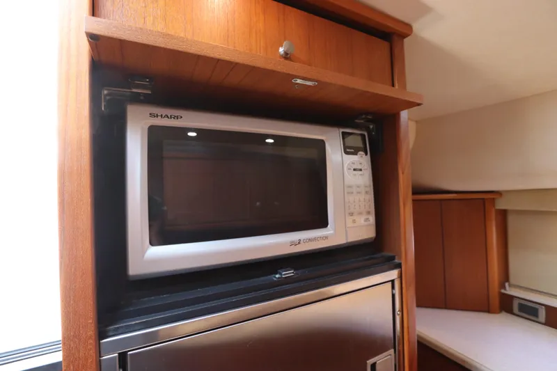 Slide: The Image of 2008 Tiara Yachts 4300 Sovran interior with Sharp microwave and wooden cabinetry. - 53
