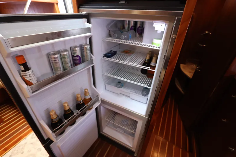Slide: The Image of Open refrigerator in 2008 Tiara Yachts 4300 Sovran, stocked with beverages and condiments. - 54