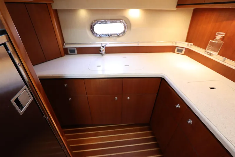 Slide: The Image of 2008 Tiara Yachts 4300 Sovran kitchen with wood cabinetry and sleek countertops. - 55