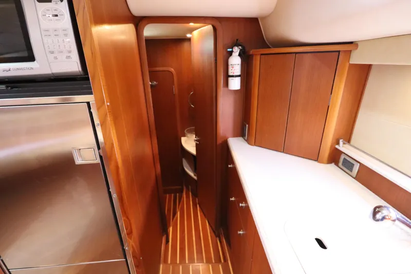 Slide: The Image of Interior of 2008 Tiara Yachts 4300 Sovran, featuring wood cabinetry and modern appliances. - 59