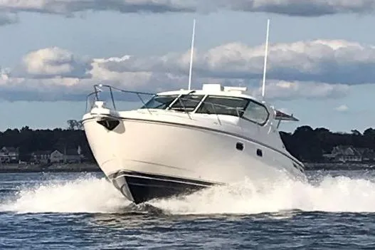 Slide: The Image of 2008 Tiara Yachts 4300 Sovran cruising on open water, showcasing sleek design and performance. - 6