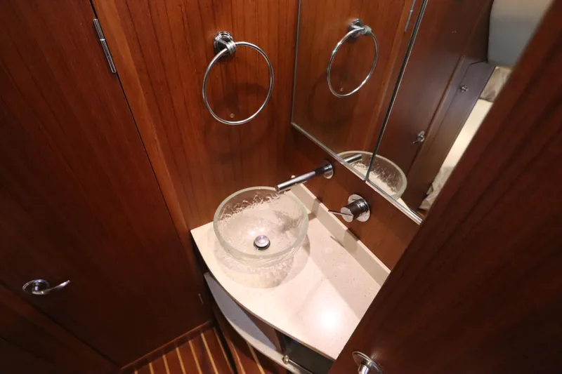 Slide: The Image of Luxurious bathroom sink in 2008 Tiara Yachts 4300 Sovran, featuring elegant wood paneling. - 60