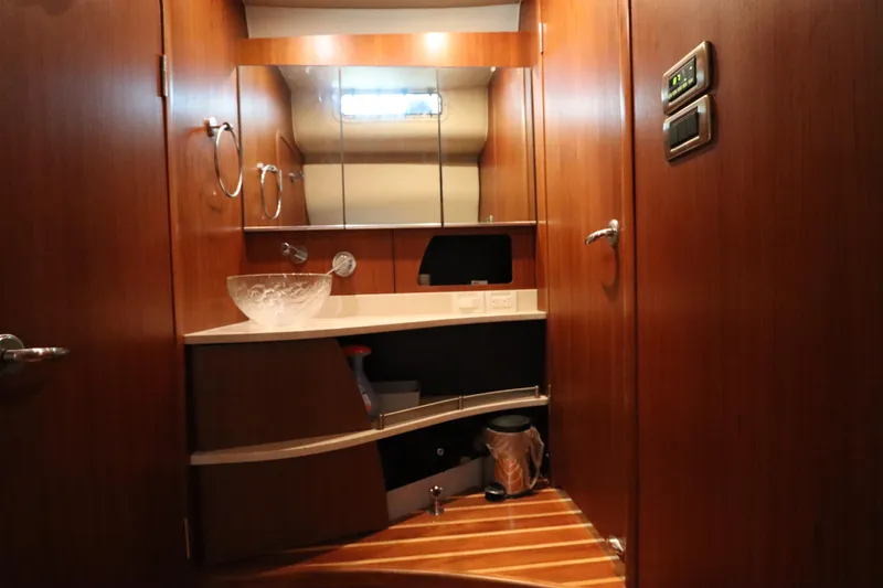 Slide: The Image of Luxurious 2008 Tiara Yachts 4300 Sovran bathroom with wooden cabinetry and modern fixtures. - 64