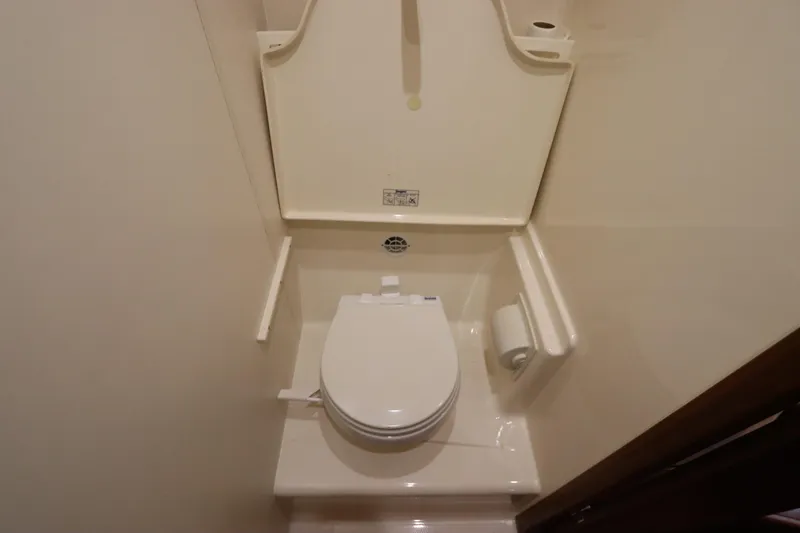 Slide: The Image of Compact bathroom in 2008 Tiara Yachts 4300 Sovran, featuring a modern toilet design. - 68