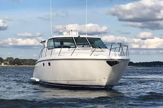 Slide: The Image of 2008 Tiara Yachts 4300 Sovran cruising on open water under a partly cloudy sky. - 7