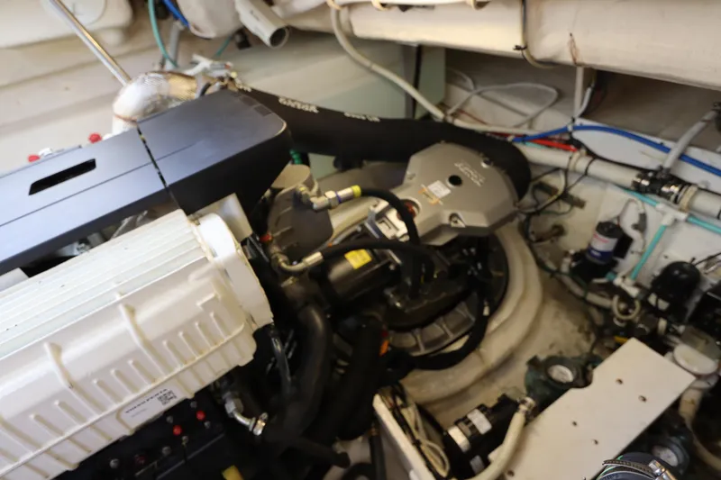 Slide: The Image of Engine room of a 2008 Tiara Yachts 4300 Sovran, showcasing mechanical components and wiring. - 74