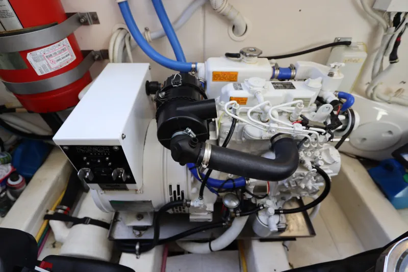 Slide: The Image of Engine room of a 2008 Tiara Yachts 4300 Sovran, featuring mechanical components and fire extinguisher. - 78