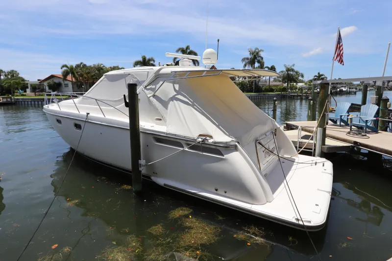 Slide: The Image of 2008 Tiara Yachts 4300 Sovran docked in a scenic marina setting. - 8
