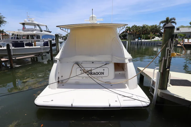 Slide: The Image of 2008 Tiara Yachts 4300 Sovran docked in a marina, rear view with cover. - 9