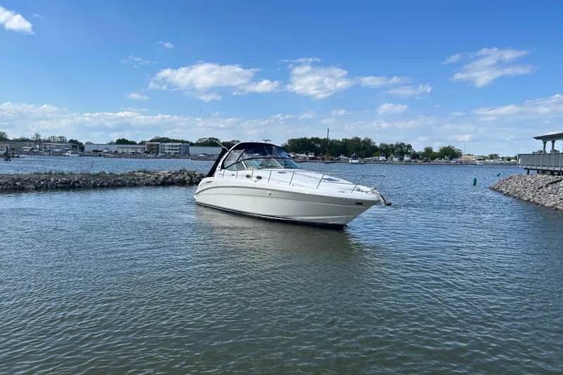 The Image of 2003 Sea Ray 360 Sundancer yacht on calm water under a clear blue sky. - 0