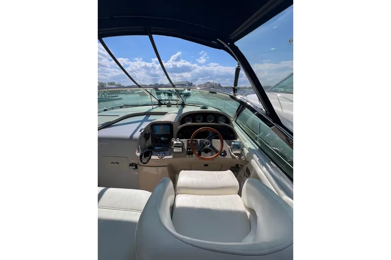 Slide: The Image of 2003 Sea Ray 360 Sundancer helm with steering wheel and navigation instruments. - 10