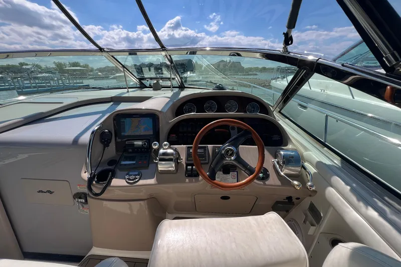Slide: The Image of Cockpit of 2003 Sea Ray 360 Sundancer with steering wheel and navigation equipment. - 11