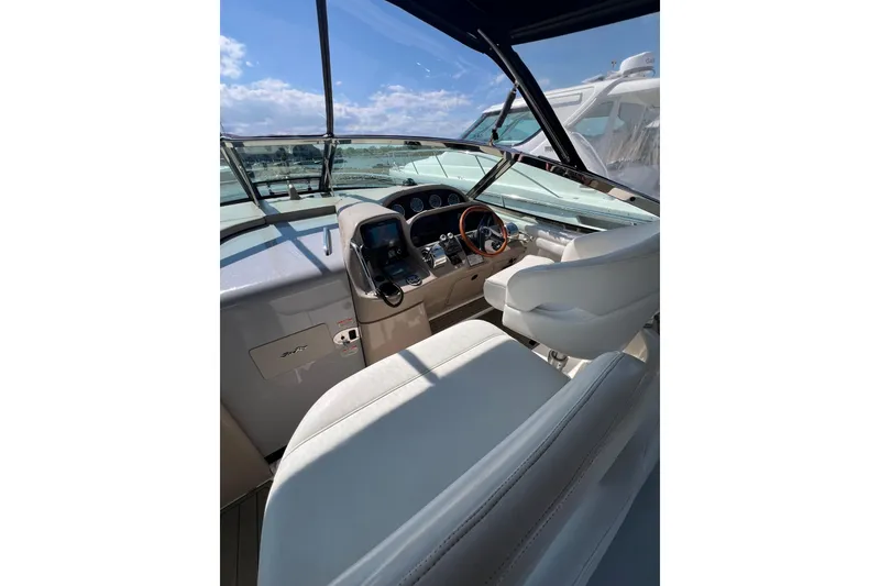 Slide: The Image of Interior view of 2003 Sea Ray 360 Sundancer yacht cockpit with steering wheel and controls. - 13