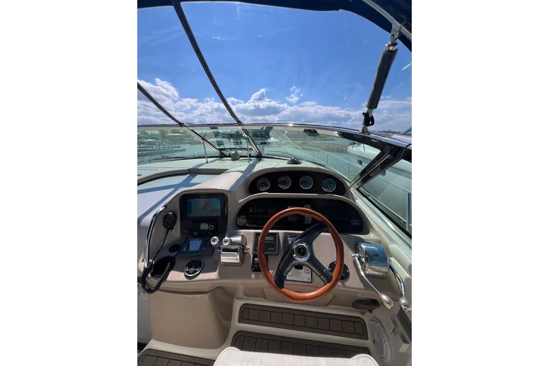 Slide: The Image of Cockpit view of 2003 Sea Ray 360 Sundancer with steering wheel and navigation instruments. - 15