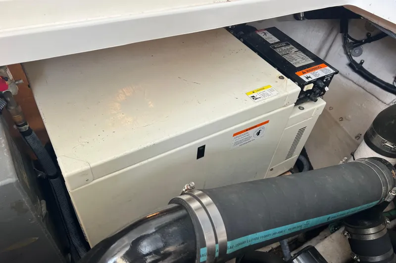 Slide: The Image of Engine compartment of a 2003 Sea Ray 360 Sundancer boat, featuring mechanical components. - 19