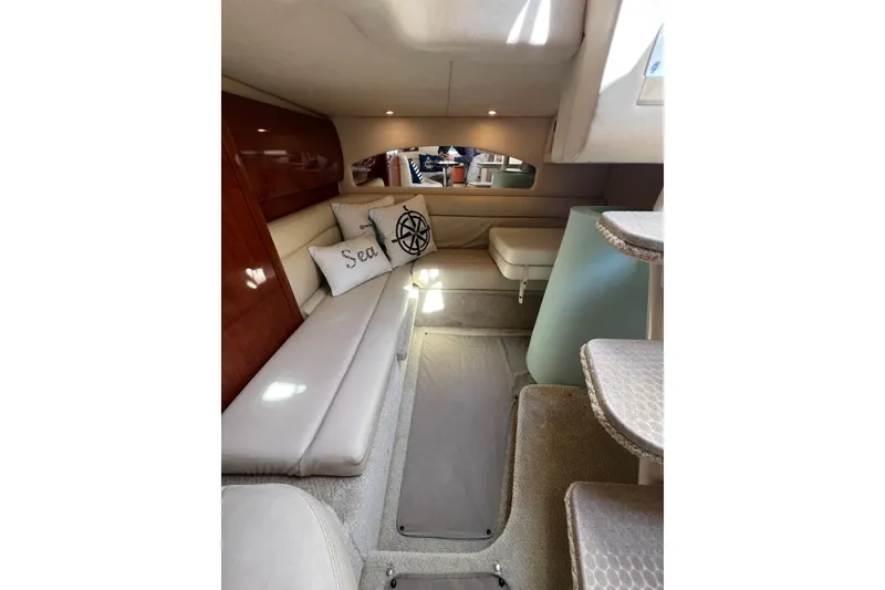 Slide: The Image of Interior of 2003 Sea Ray 360 Sundancer yacht, featuring cozy seating and nautical decor. - 26